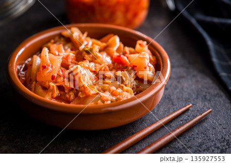 Fermented cabbage. Kimchi. Korean food in bowl on black table. Fermented cabbage. Kimchi. Korean food in bowl on black table. 135927553