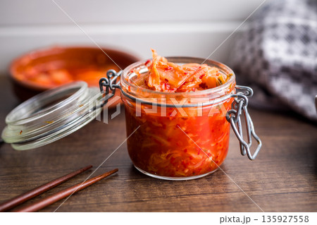 Fermented cabbage. Kimchi. Korean food in jar on wooden table. Fermented cabbage. Kimchi. Korean food in jar on wooden table. 135927558