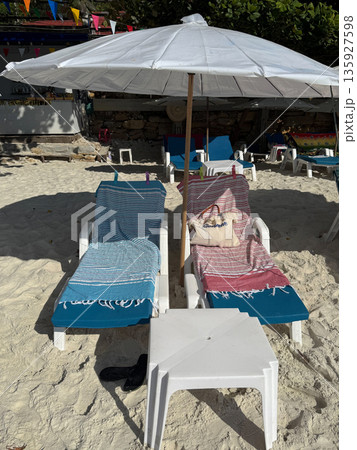 Empty Beach Sunbeds Under White Umbrella 135927598