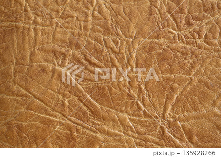 Brown textured leather background. Natural texture close-up. Useful as background for design-works. 135928266