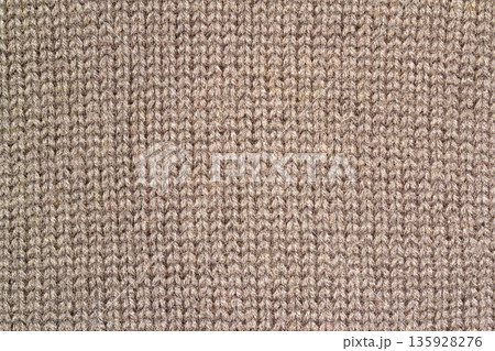 Background texture of beige pattern knitted fabric made of cotton or wool closeup Background texture of beige pattern knitted fabric made of cotton or wool closeup 135928276