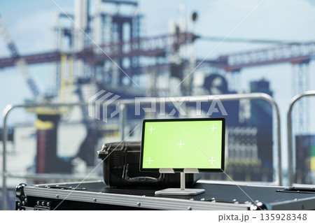 Green screen mockup tablet on offshore platform deck used to monitor gear performance in real time. Chroma key device on drilling rig boat used to calibrate infrastructure, close up shot 135928348