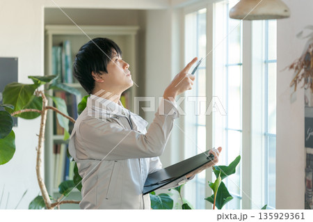 室内設備を点検する作業服の男性 室内設備を点検する作業服の男性 135929361