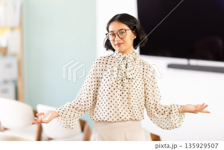 Young woman student standing in lecture hall 135929507