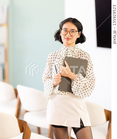 Portrait of female teacher with an electronic tablet in her hands Portrait of female teacher with an electronic tablet in her hands 135929523