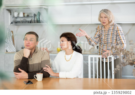 Family quarrel, adult woman calming man 135929802