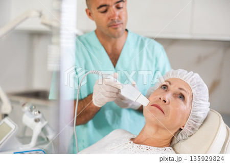 Using skin scrubber Using skin scrubber 135929824