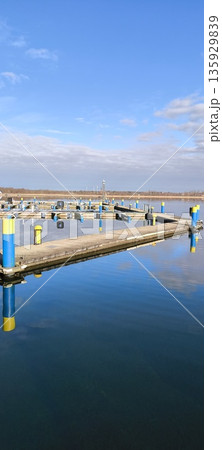 pier for boats, yachts, sailboats, blue sky, blue water, lake, sun, clouds, marina 135929839