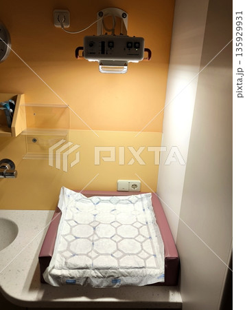 Professional changing table with infrared heating in the clinic Professional changing table with infrared heating in the clinic 135929931