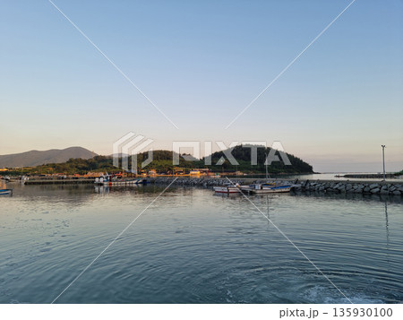 This is a view of an island village at sunset. This is a view of an island village at sunset. 135930100