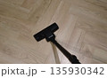 Vacuum cleaner floor nozzle on light wooden parquet, close-up 135930342