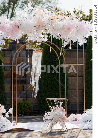 Elegant Wedding Arch Decorated with White and Pink Flowers and Crystal Chandelier for Romantic Outdoor Ceremony 135931514