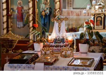 Orthodox Church Interior with Golden Cross and Religious Icons During Holy Week Celebration Orthodox Church Interior with Golden Cross and Religious Icons During Holy Week Celebration 135931531