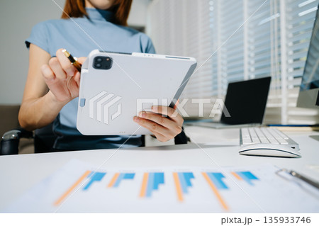 Businesswoman hand working digital marketing media in virtual screen with mobile phone and modern compute with VR icon diagram at office Businesswoman hand working digital marketing media in virtual screen with mobile phone and modern compute with VR icon diagram at office 135933746