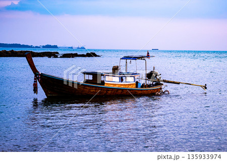 Thai traditional wooden longtail boat in the sea Thai traditional wooden longtail boat in the sea 135933974