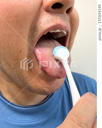 舌磨きで口腔ケアする男性 舌磨きで口腔ケアする男性 135934195