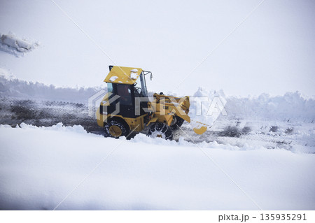 雪に覆われた駐車場を除雪する除雪車両 雪に覆われた駐車場を除雪する除雪車両 135935291