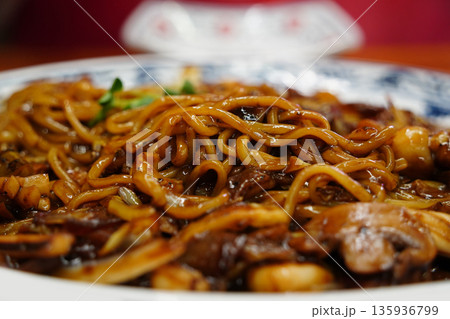 Delicious Korean-style Chinese seafood Jajangmyeon (black bean sauce noodles) served on a platter at a restaurant 135936799