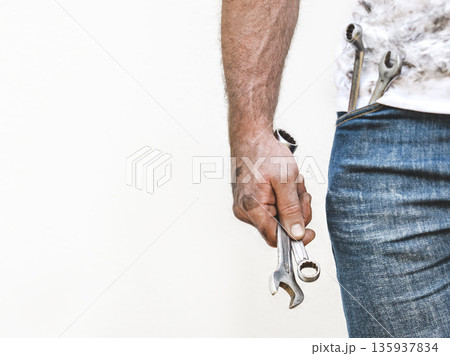 Handsome worker, hand tools and dirty shirt Handsome worker, hand tools and dirty shirt 135937834