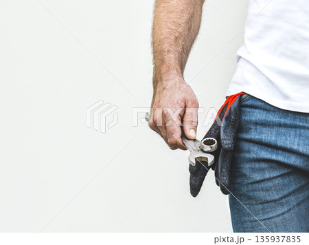 Attractive man and spanners. Studio shot Attractive man and spanners. Studio shot 135937835