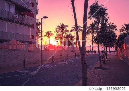 A deserted street leading to the embankment in the early morning during sunrise. Avenida de Benidorm, Sant Joan d'Alacant, Alicante, Spain A deserted street leading to the embankment in the early morning during sunrise. Avenida de Benidorm, Sant Joan d'Alacant, Alicante, Spain 135938095