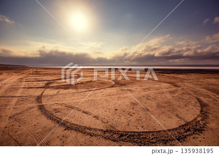 Car tracks in the sand. Salt marsh beach at sunset Car tracks in the sand. Salt marsh beach at sunset 135938195