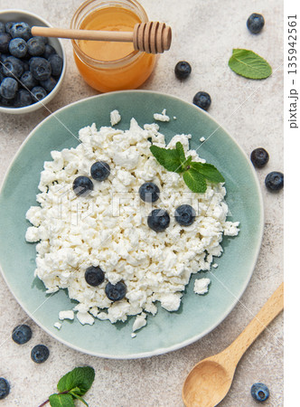 Cottage cheese with blueberries honey and mint healthy breakfast 135942561