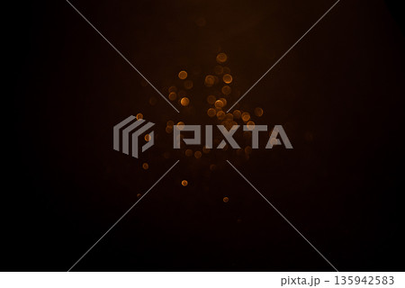 Golden abstract bokeh on black background. 135942583