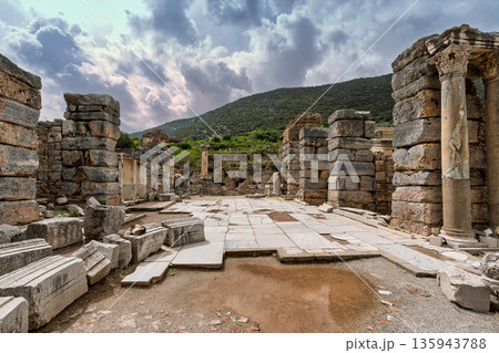 Dramatic cloudy sky over the ancient ruins of Ephesus, historic columns and stone blocks, Selcuk, Izmir Province, Turkey Dramatic cloudy sky over the ancient ruins of Ephesus, historic columns and stone blocks, Selcuk, Izmir Province, Turkey 135943788
