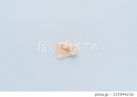 Chewed chewing gum blob on blue background, minimal concept Chewed chewing gum blob on blue background, minimal concept 135944216