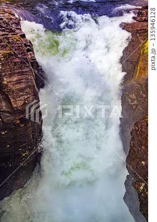 Gudbrandsjuvet Nature park. Waterfall in Valldal on the Valldola river, Norway, Europe. Vertical photo 135946128