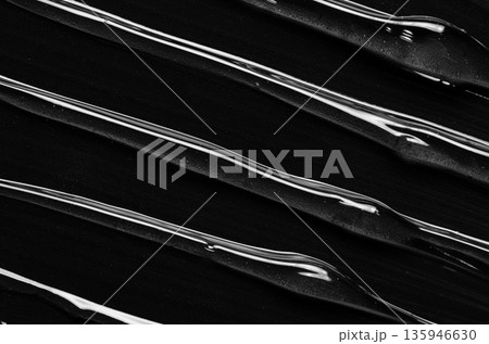 A moisturizer or body gel or a facial serum. Black background. A moisturizer or body gel or a facial serum. Black background. 135946630