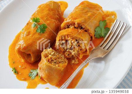 Stuffed cabbage rolls with quinoa and tomato sauce Stuffed cabbage rolls with quinoa and tomato sauce 135949038