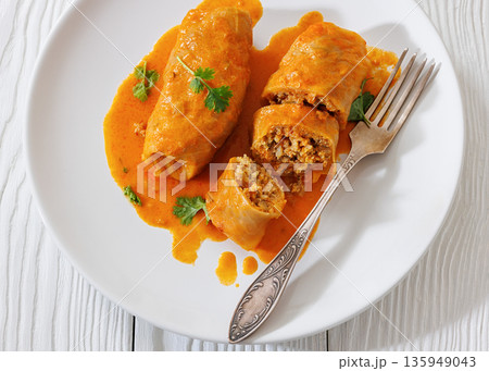 Stuffed cabbage rolls with quinoa and tomato sauce Stuffed cabbage rolls with quinoa and tomato sauce 135949043