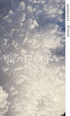 Detailed macro shot of white sparkling snow crystals and fresh frost texture in winter. 135949299