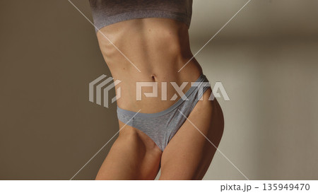 Female body close up in gray underwear in studio. 135949470
