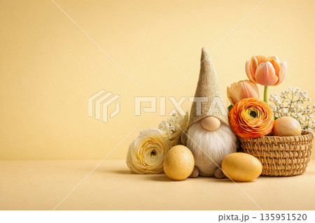 Easter gnome with eggs and spring flowers on yellow background with copy space 135951520
