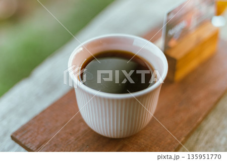 black drip coffee in ceramic cup. black drip coffee in ceramic cup. 135951770