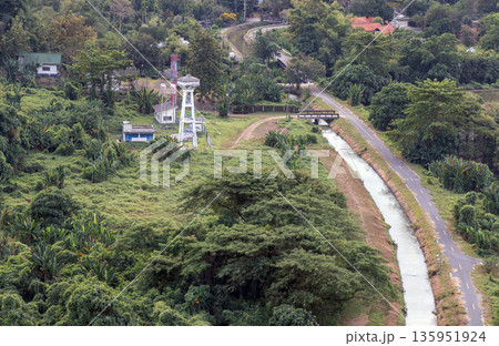 Canal and drainage system from Drainage Khun Dan Prakan Chon Dam with scenery cuts through lush green hills amidst beautiful nature. 135951924