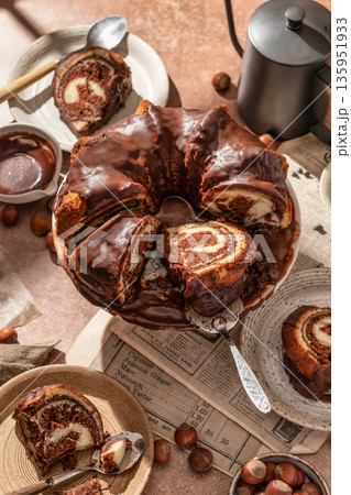 Chocolate marble bundt cake or zebra cake with chocolate glaze sliced on brown table background Chocolate marble bundt cake or zebra cake with chocolate glaze sliced on brown table background 135951933