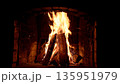 A blazing fire in a stone fireplace at home 135951979