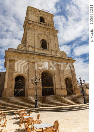 The Enna Cathedral at sunset with people sitting in front of it on stairs The Enna Cathedral at sunset with people sitting in front of it on stairs 135952231