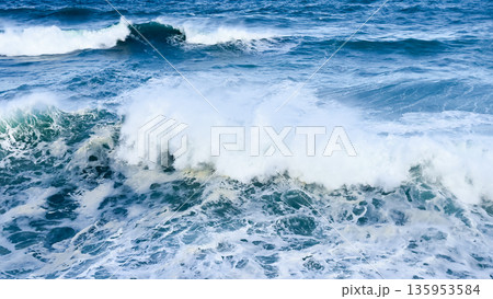 Powerful ocean waves crashing in deep blue sea Powerful ocean waves crashing in deep blue sea 135953584