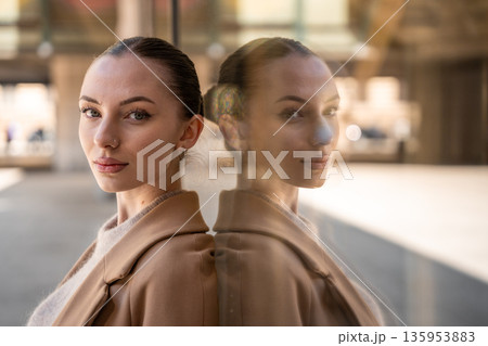 Portrait of young beautiful woman wearing coat walking in the city centre of Prague, Europe 135953883