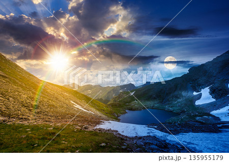mountain lake in alpine summer landscape. day and night time change concept. beautiful view surrounded with sun and moon at twilight. fresh water, snow and rocky slopes. remote highlands adventures 135955179