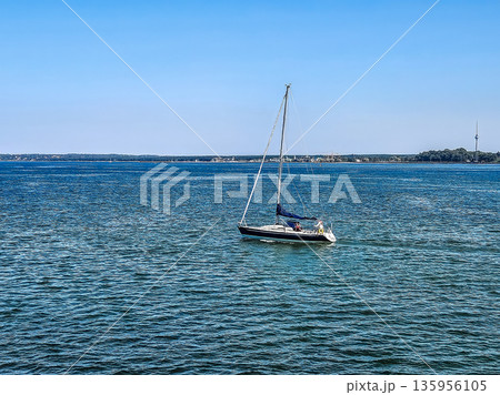 Sailing in Tallinn Bay, Estonia, with the TV Tower on the horizon on a sunny day. Sailing in Tallinn Bay, Estonia, with the TV Tower on the horizon on a sunny day. 135956105