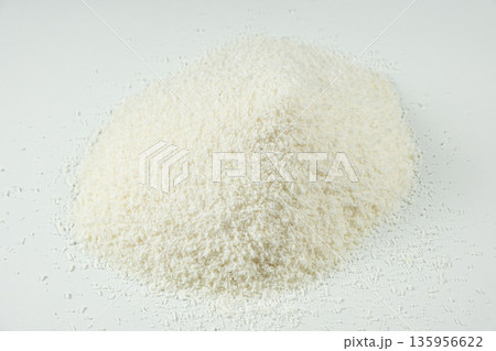 Pile of coconut flakes on white background macro Pile of coconut flakes on white background macro 135956622