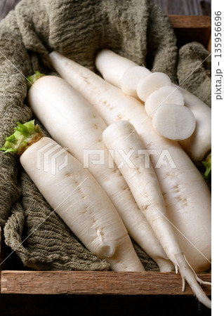 Close up of daikon radish in wooden box with cloth 135956696
