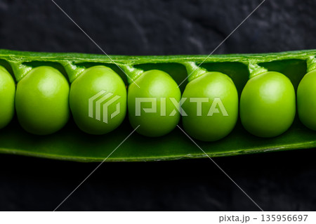 Close up of fresh green peas in pod showing natural texture 135956697