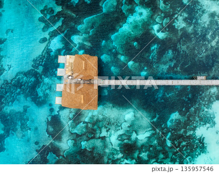 Aerial view of bungalow, jetty, blue sea on summer sunny day 135957546